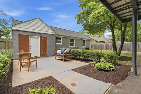 a front view of a house with outdoor seating