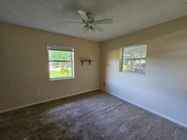3261 Southwest 22nd Street Okeechobee, FL 34974 - Photo 11 of 15 an empty room with a window and a ceiling fan