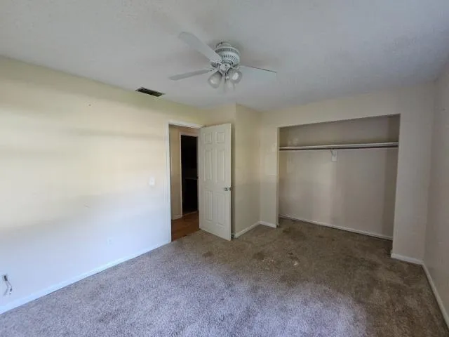 an empty room with a empty space and a ceiling fan