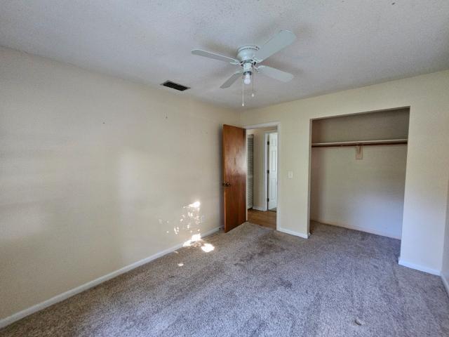 3261 Southwest 22nd Street Okeechobee, FL 34974 - Photo 14 of 15 an empty room with closet and a chandelier fan
