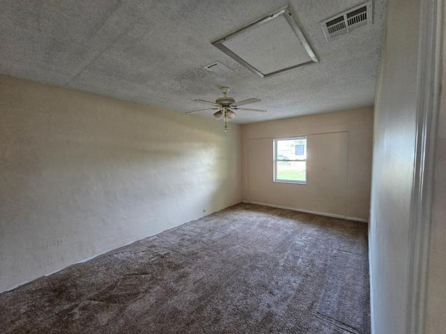 3261 Southwest 22nd Street Okeechobee, FL 34974 - Photo 5 of 15 an empty room that has a window in it