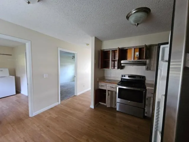 a kitchen with stainless steel appliances granite countertop a stove and a refrigerator
