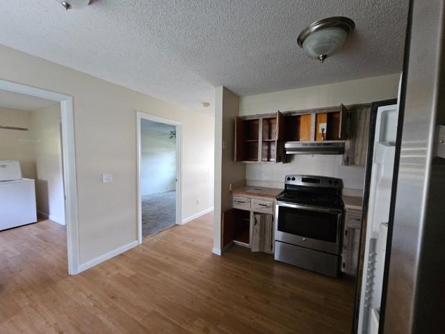 3261 Southwest 22nd Street Okeechobee, FL 34974 - Photo 10 of 15 a kitchen with stainless steel appliances granite countertop a stove and a refrigerator
