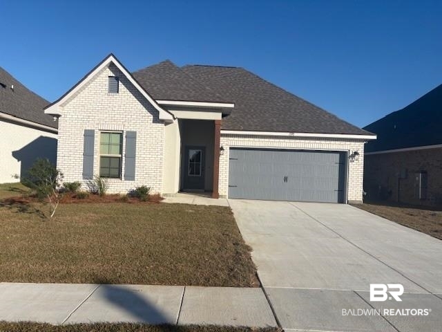 1370 Fenton Circle Foley, AL 36535 - Photo 1 of 3 Ranch-style home featuring brick siding, concrete driveway, a garage, and a front lawn