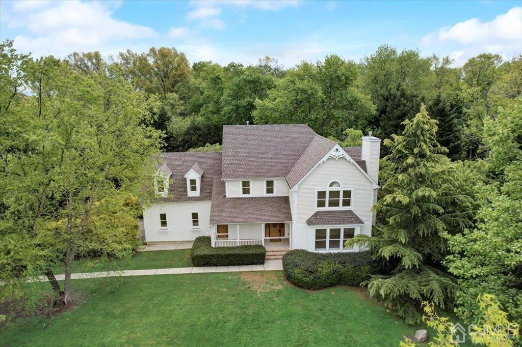 100 North Main Street Cranbury, NJ 08512 - Photo 1 of 74 a aerial view of a house next to a big yard and large trees