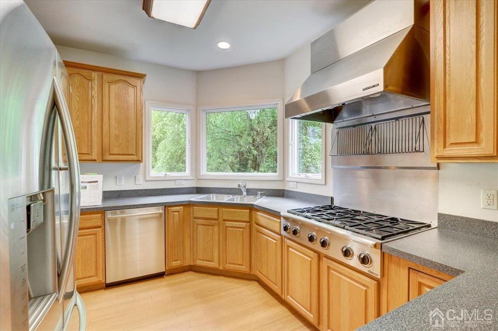 100 North Main Street Cranbury, NJ 08512 - Photo 14 of 74 a kitchen with stainless steel appliances a stove a sink and a refrigerator