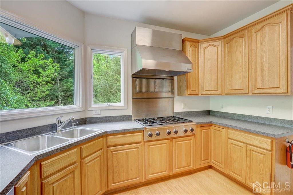 100 North Main Street Cranbury, NJ 08512 - Photo 15 of 74 a kitchen with stainless steel appliances granite countertop a sink a stove cabinets and a window