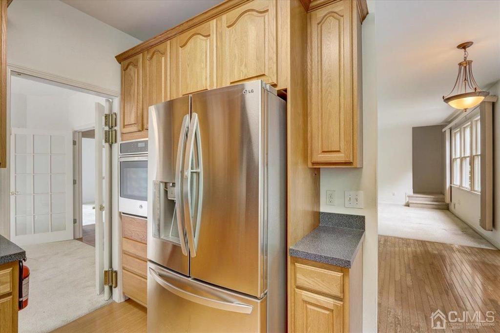 100 North Main Street Cranbury, NJ 08512 - Photo 16 of 74 a kitchen with stainless steel appliances a refrigerator and a stove