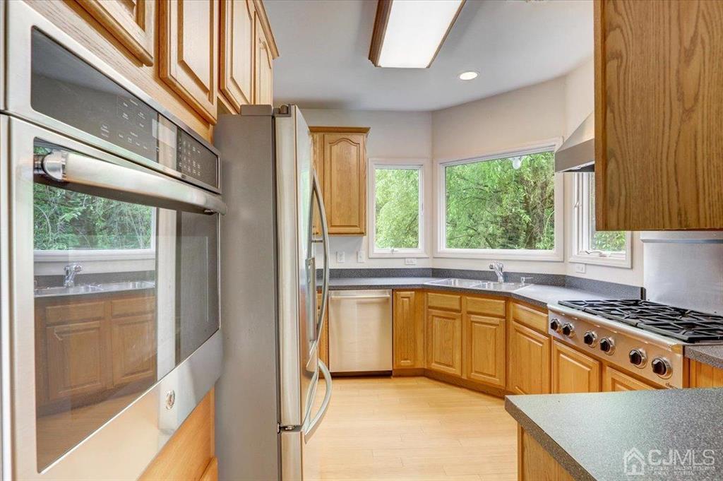 100 North Main Street Cranbury, NJ 08512 - Photo 17 of 74 a kitchen with stainless steel appliances granite countertop a stove and a sink