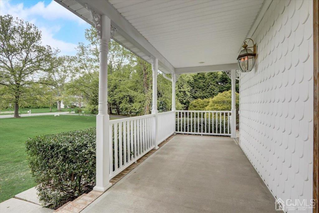 100 North Main Street Cranbury, NJ 08512 - Photo 3 of 74 a view of a porch with a floor to ceiling window and a yard