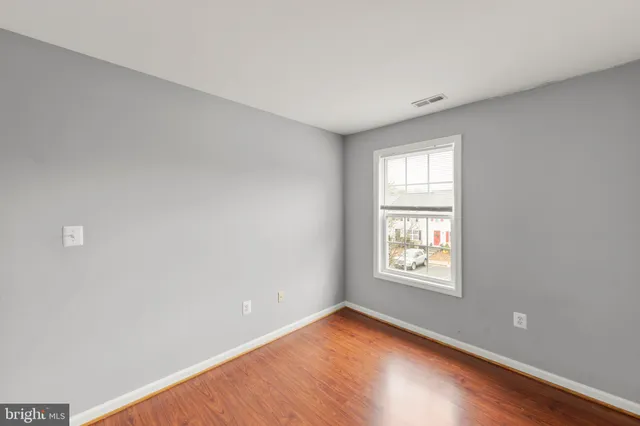 a view of a yard with wooden fence