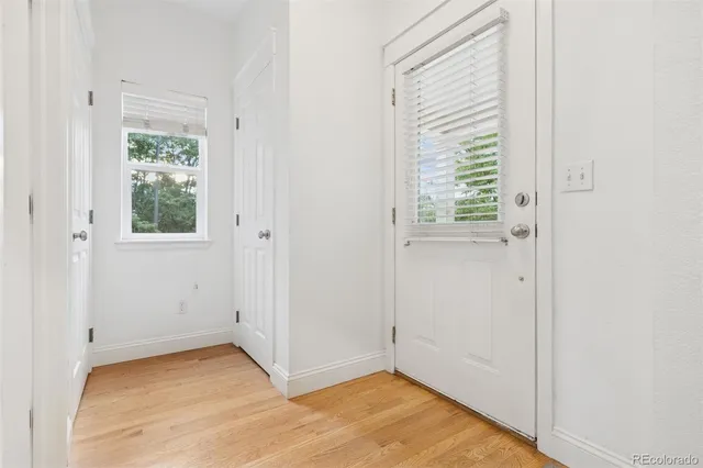 a view of an empty room with closet and windows