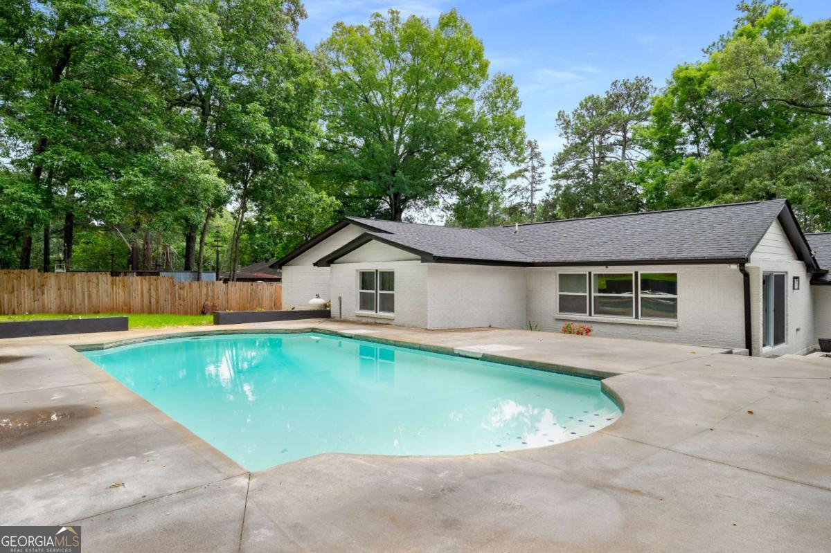 3154 North Druid Hills Road Decatur, GA 30033 - Photo 11 of 84 a view of a house with a swimming pool and sitting area