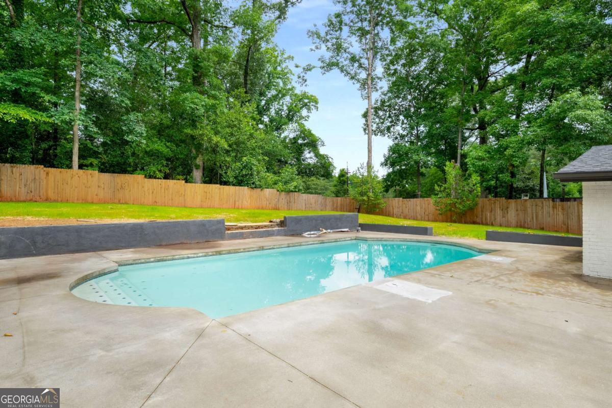 3154 North Druid Hills Road Decatur, GA 30033 - Photo 12 of 84 a view of a swimming pool with an outdoor space and seating area