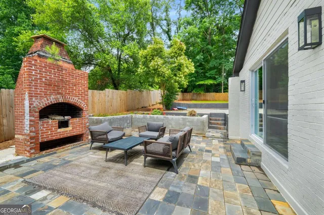 a view of a dining room with furniture a chandelier and wooden floor
