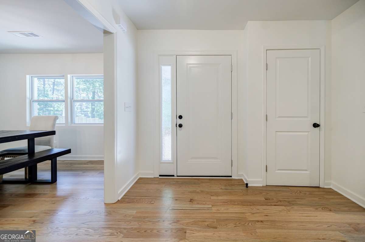 3154 North Druid Hills Road Decatur, GA 30033 - Photo 24 of 84 an empty room with wooden floor and windows