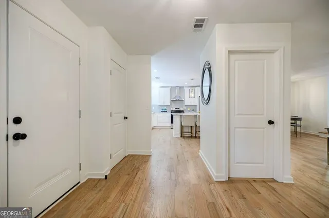 a kitchen with stainless steel appliances granite countertop a sink and dishwasher a stove top oven with wooden floor