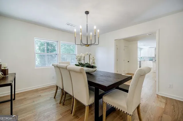 a kitchen with granite countertop a sink stainless steel appliances and cabinets