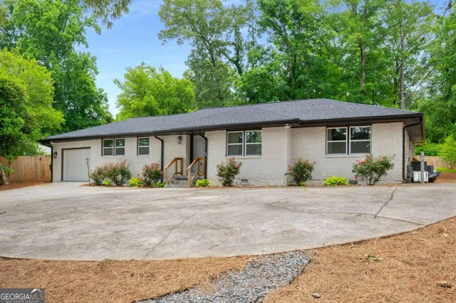 a backyard of a house with a large tree