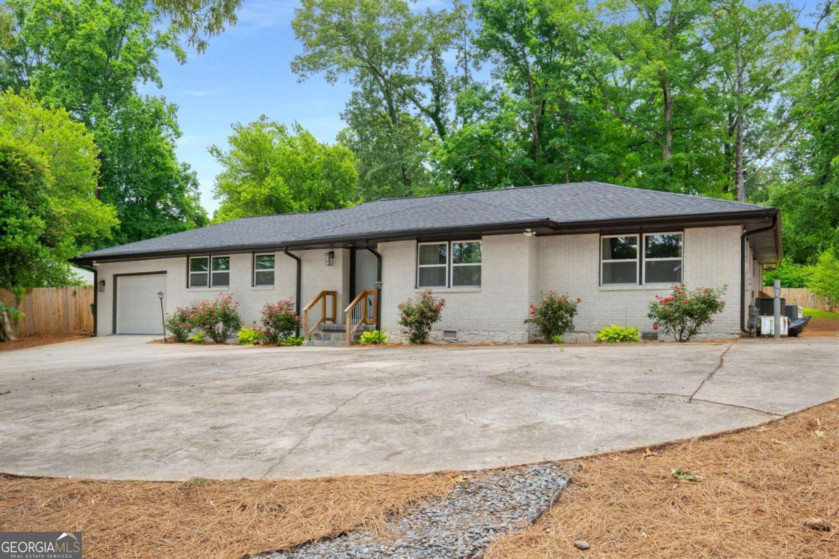 3154 North Druid Hills Road Decatur, GA 30033 - Photo 3 of 84 a front view of a house with a garden