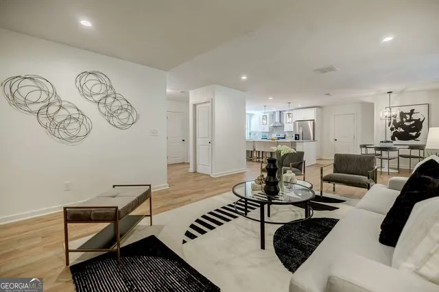 an empty room with wooden floor cabinet and windows