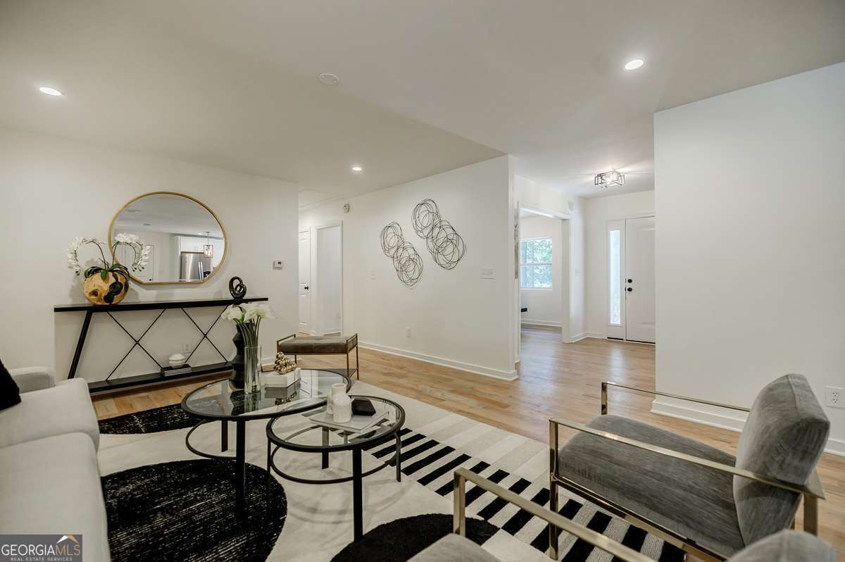 3154 North Druid Hills Road Decatur, GA 30033 - Photo 35 of 84 a living room with furniture a rug and a window