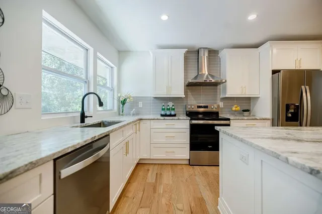 a view of a livingroom with furniture and wooden floor