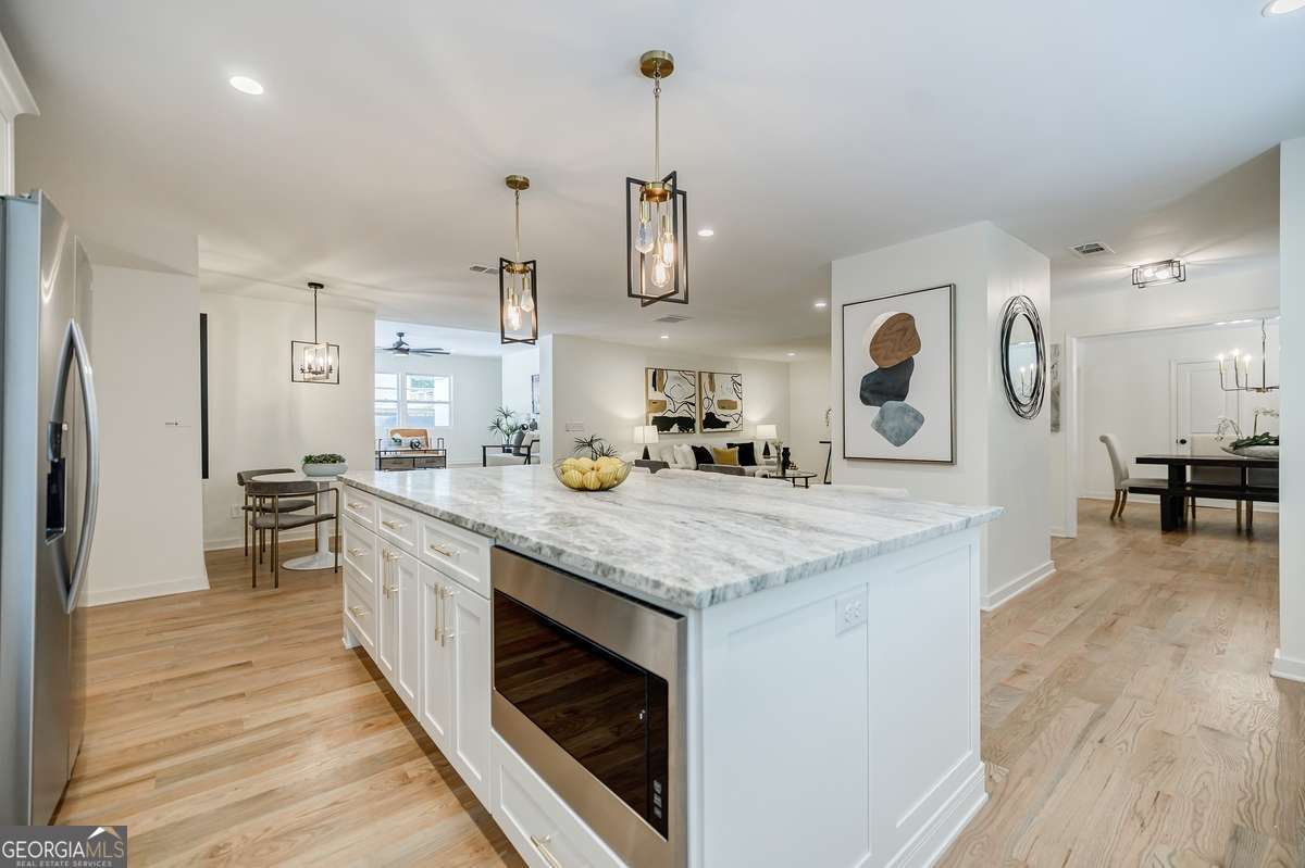 3154 North Druid Hills Road Decatur, GA 30033 - Photo 44 of 84 a kitchen with stainless steel appliances granite countertop wooden floors and sink