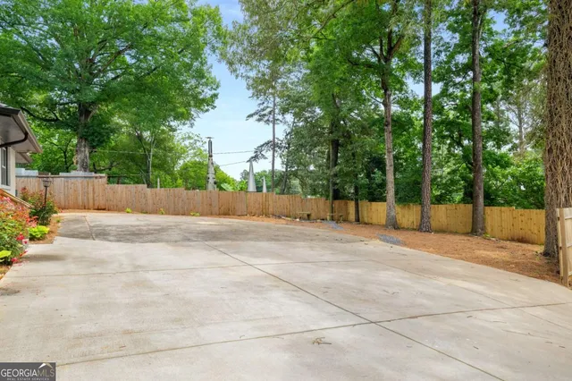 a view of a swimming pool with a yard and a sitting area