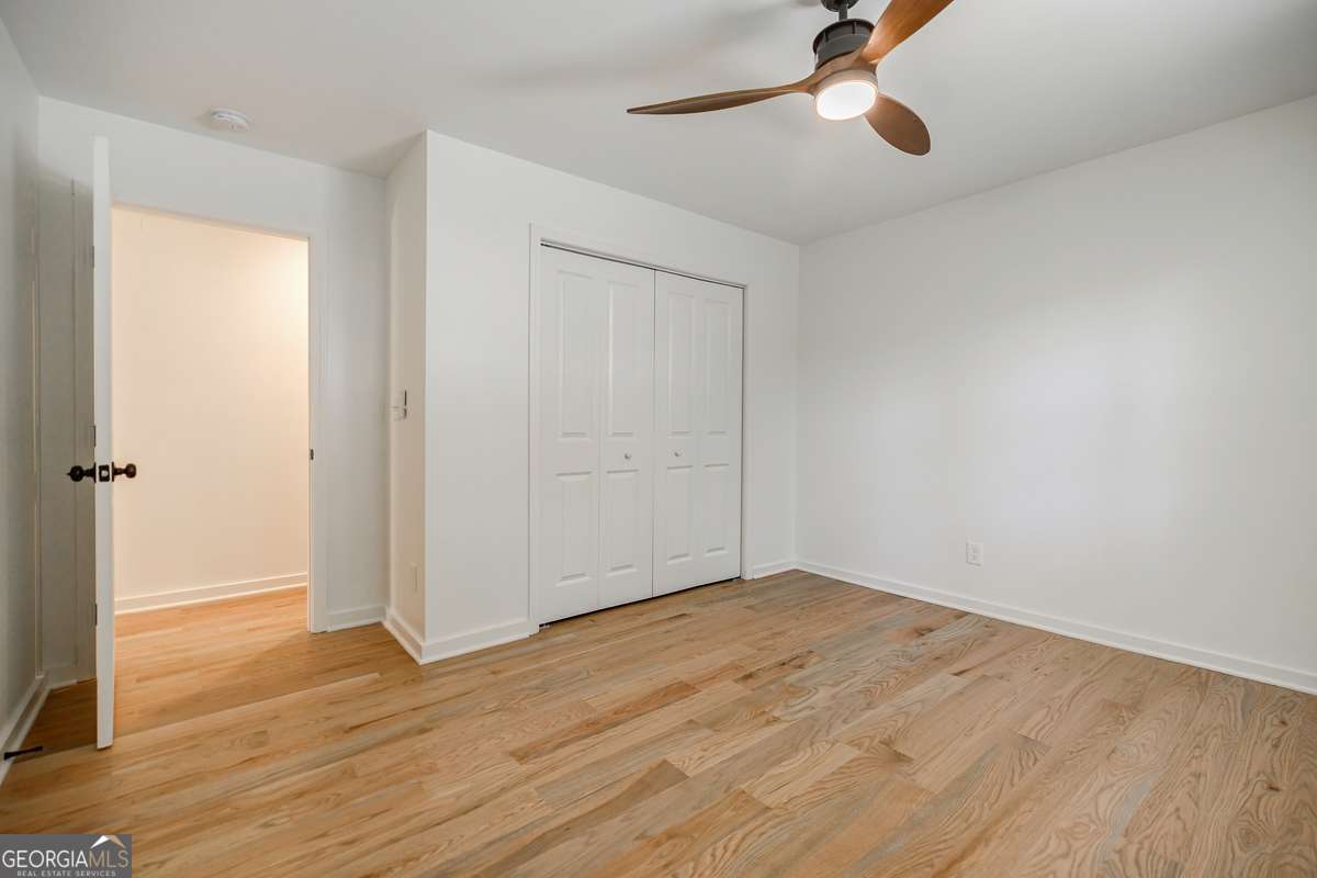 3154 North Druid Hills Road Decatur, GA 30033 - Photo 51 of 84 an empty room with wooden floor cabinet and windows