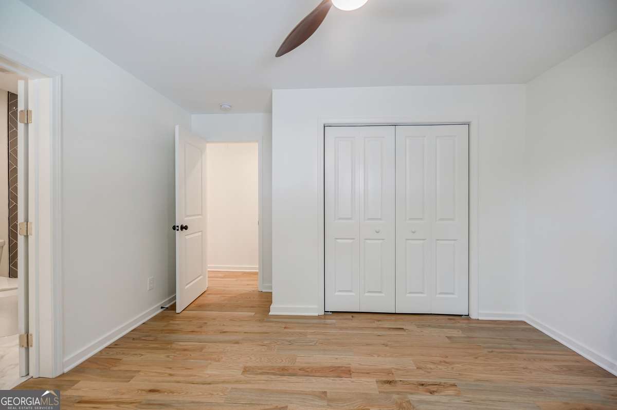 3154 North Druid Hills Road Decatur, GA 30033 - Photo 52 of 84 a view of an empty room with wooden floor