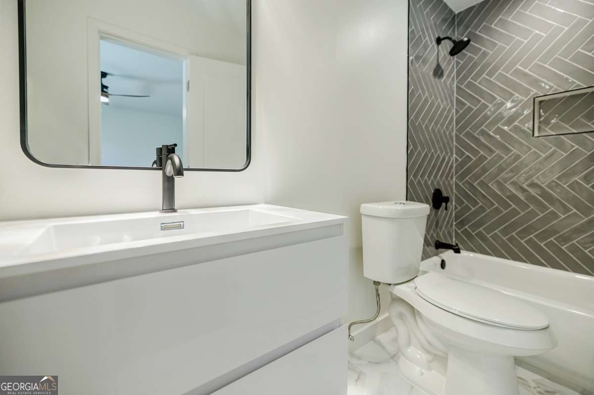 3154 North Druid Hills Road Decatur, GA 30033 - Photo 54 of 84 a bathroom with a sink a toilet and shower