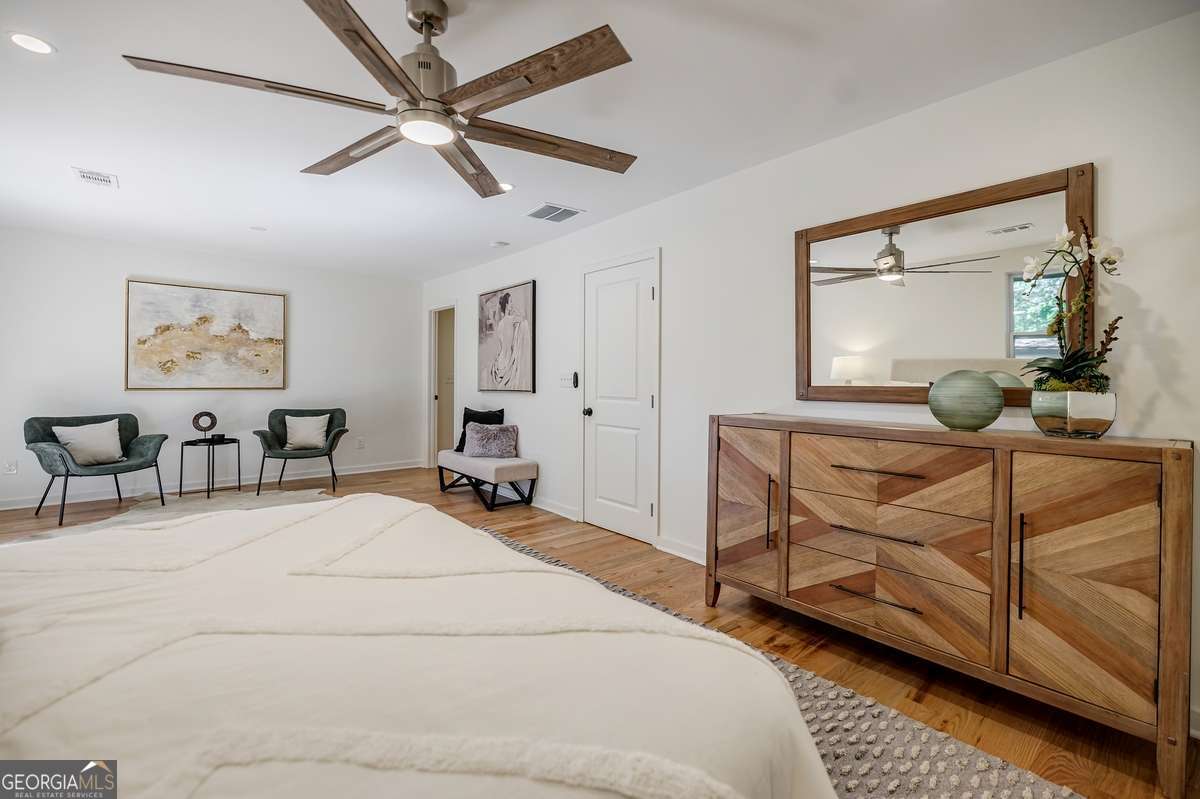 3154 North Druid Hills Road Decatur, GA 30033 - Photo 59 of 84 a bedroom with a bed a chandelier and dresser