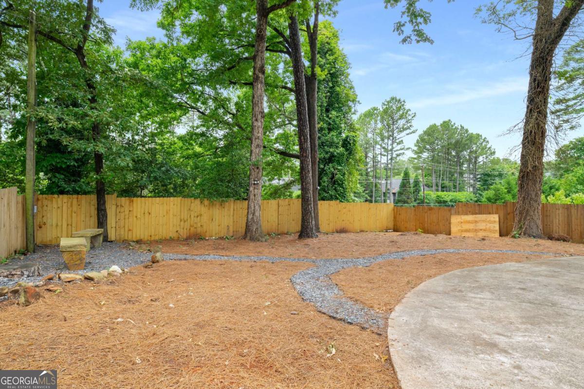 3154 North Druid Hills Road Decatur, GA 30033 - Photo 6 of 84 a backyard of a house with a large tree