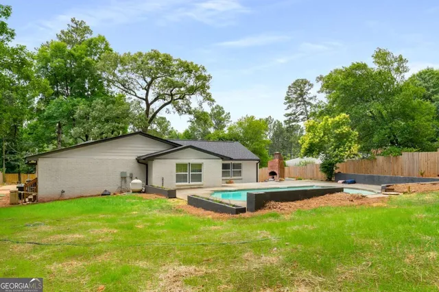a view of a swimming pool with an outdoor space and seating area
