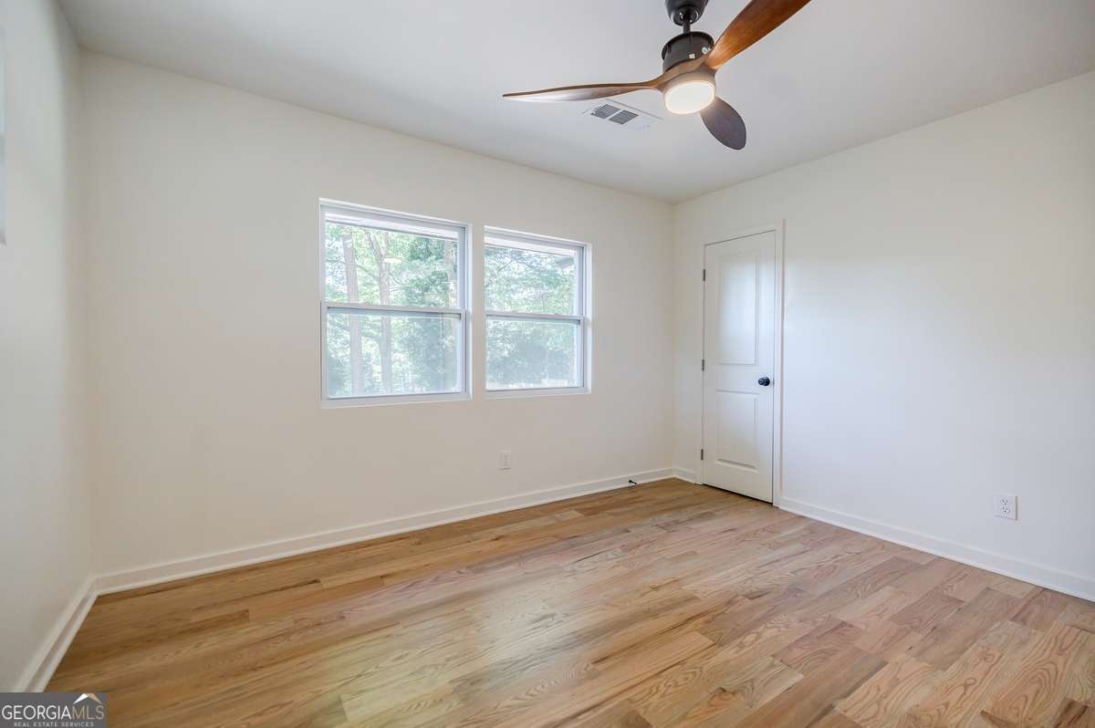 3154 North Druid Hills Road Decatur, GA 30033 - Photo 77 of 84 wooden floor in an empty room with a window