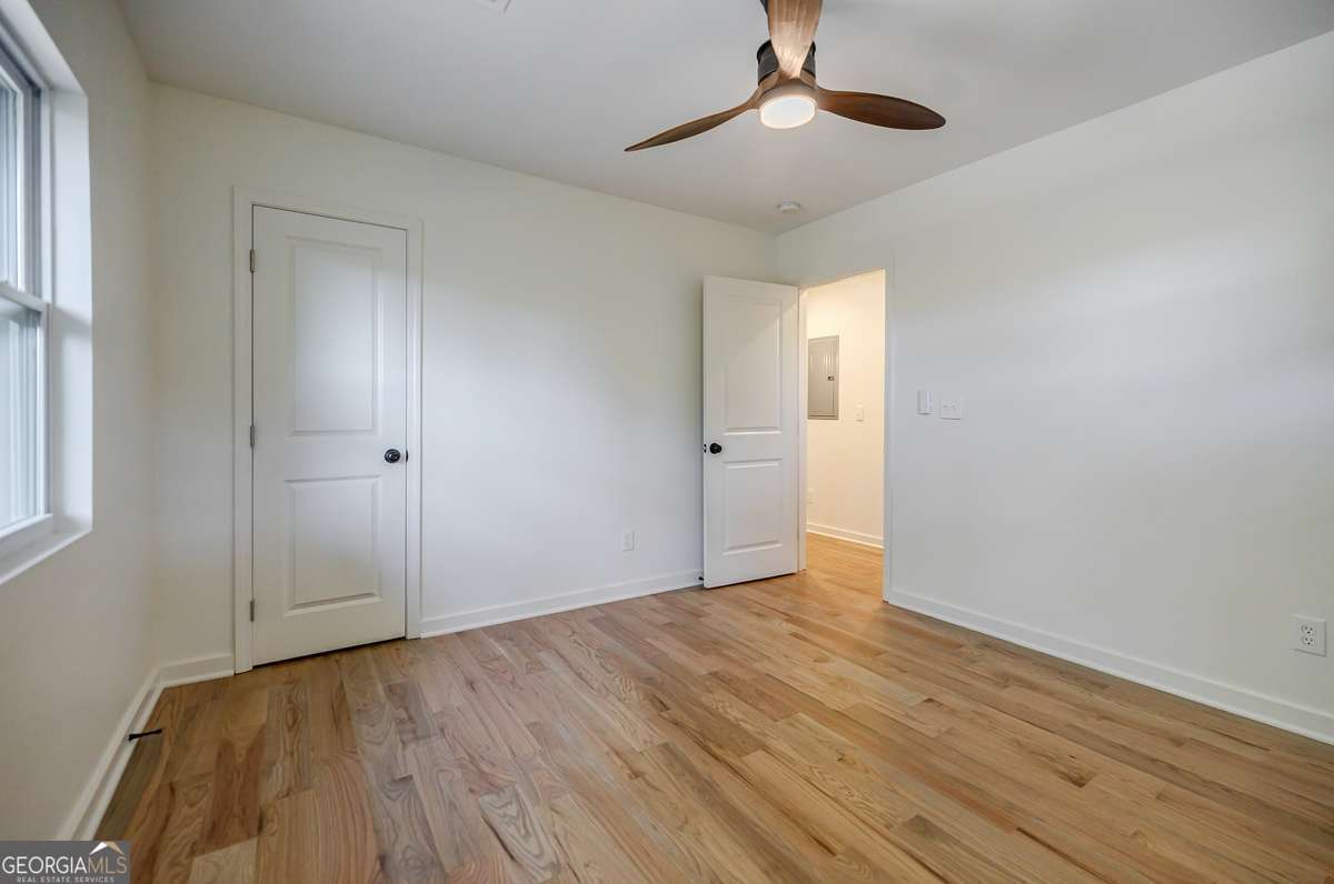 3154 North Druid Hills Road Decatur, GA 30033 - Photo 78 of 84 a view of an empty room with wooden floor and a window