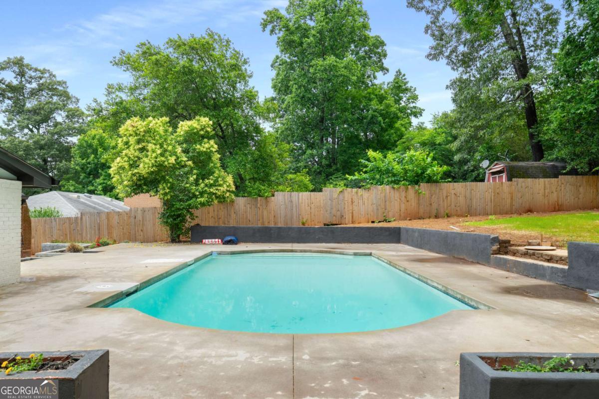 3154 North Druid Hills Road Decatur, GA 30033 - Photo 10 of 84 a view of a swimming pool with a yard and a sitting area