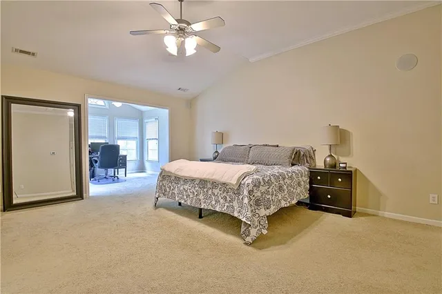 a bedroom with a large bed and a window