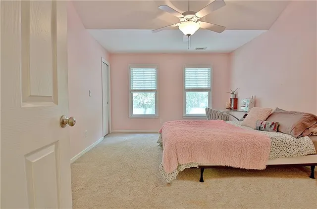 a view of a livingroom with furniture and a ceiling fan