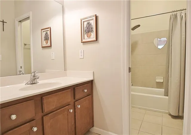 a kitchen with kitchen island a counter top space appliances and a refrigerator