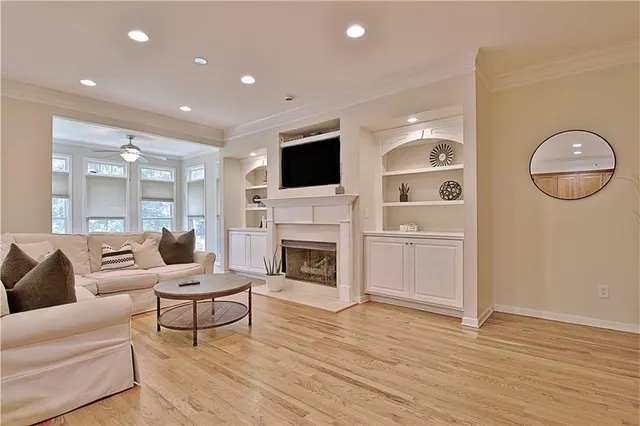 a living room with furniture a fireplace and a flat screen tv
