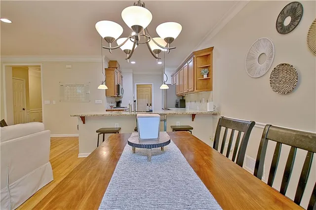 a living room with couches chair and a dining table with wooden floor