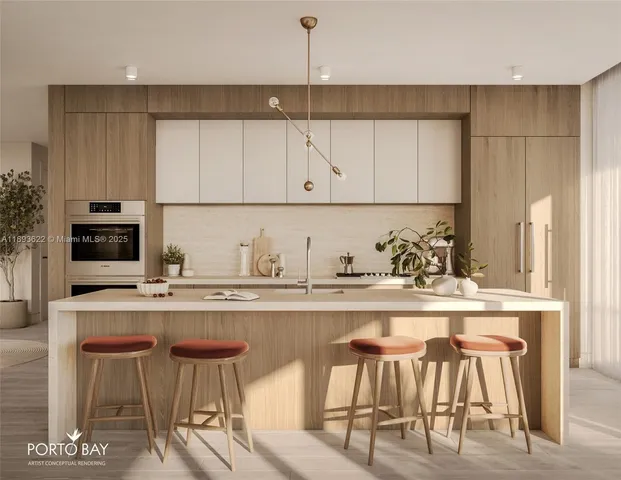 a kitchen with stainless steel appliances granite countertop a table chairs sink and cabinets
