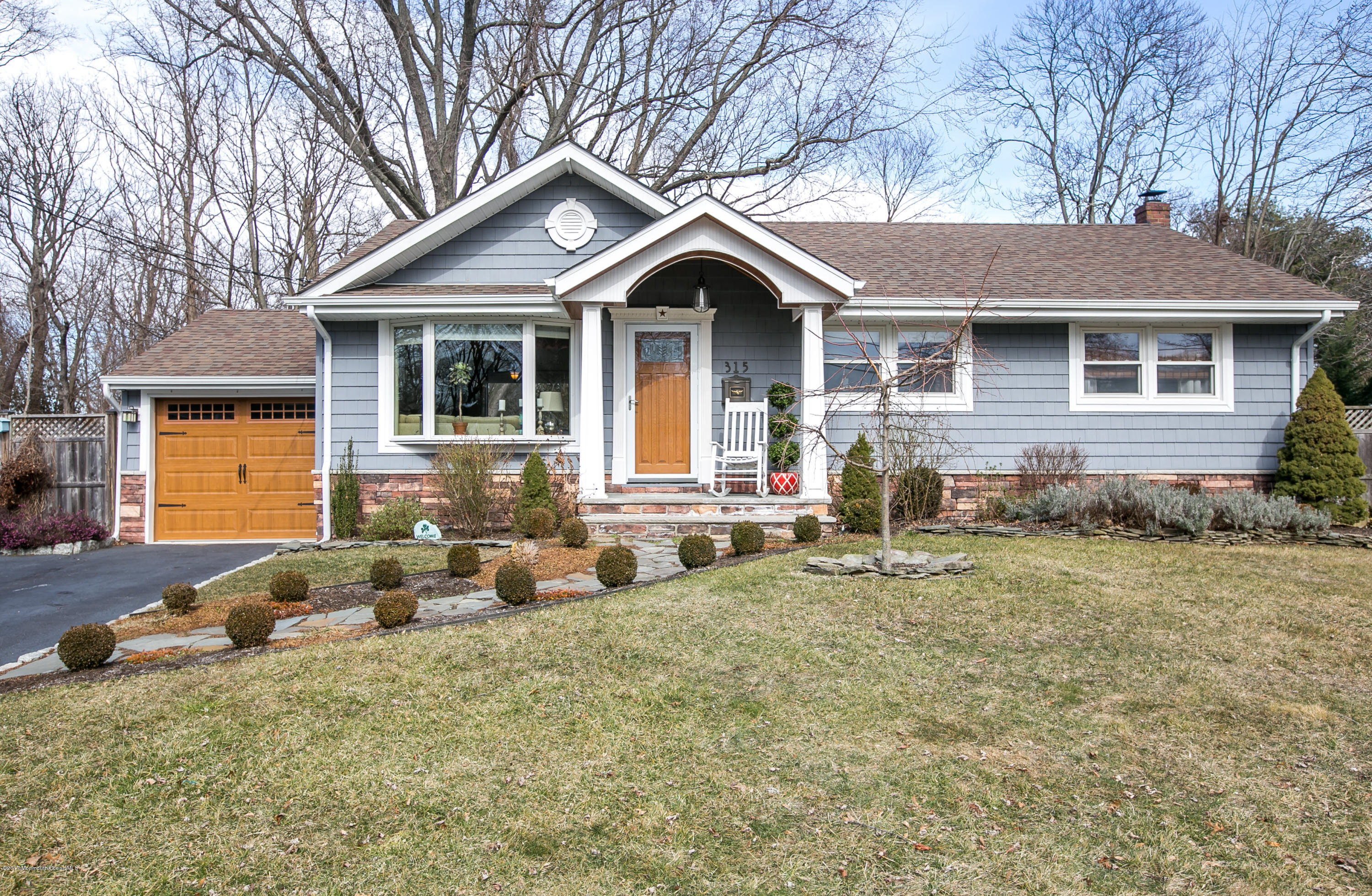 a front view of a house with garden