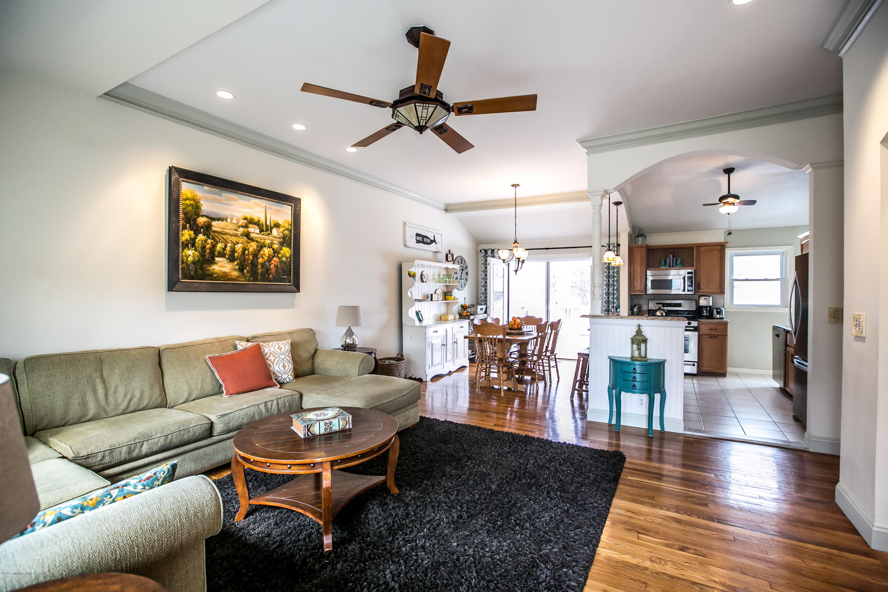 315 Edgemoor Road Middletown, NJ 07718 - Photo 3 of 28 a living room with furniture kitchen view and a chandelier