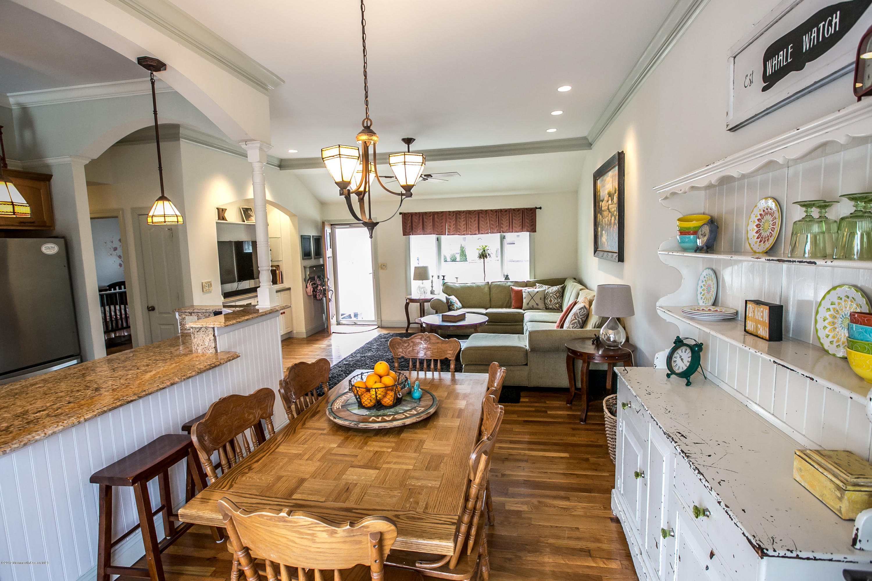 315 Edgemoor Road Middletown, NJ 07718 - Photo 4 of 28 a view of a dining room and livingroom with furniture wooden floor a chandelier