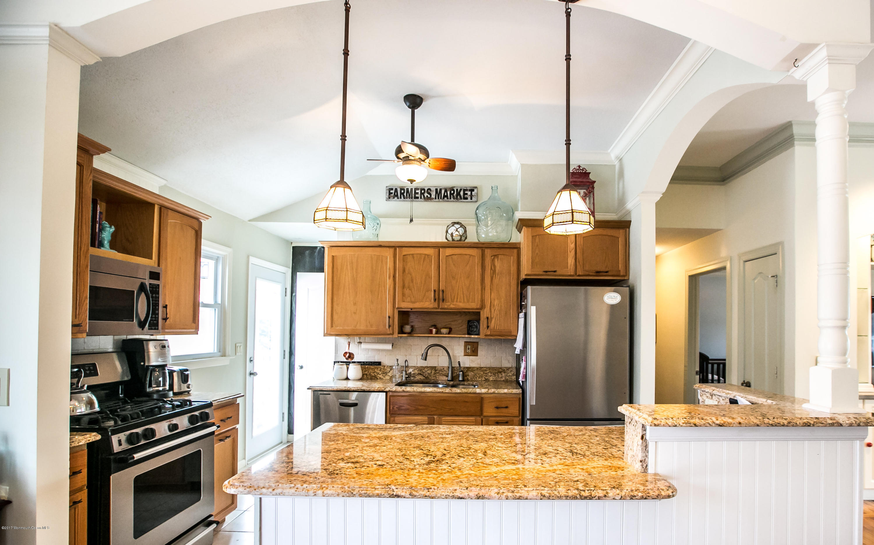 315 Edgemoor Road Middletown, NJ 07718 - Photo 5 of 28 a kitchen with kitchen island granite countertop a stove and a sink