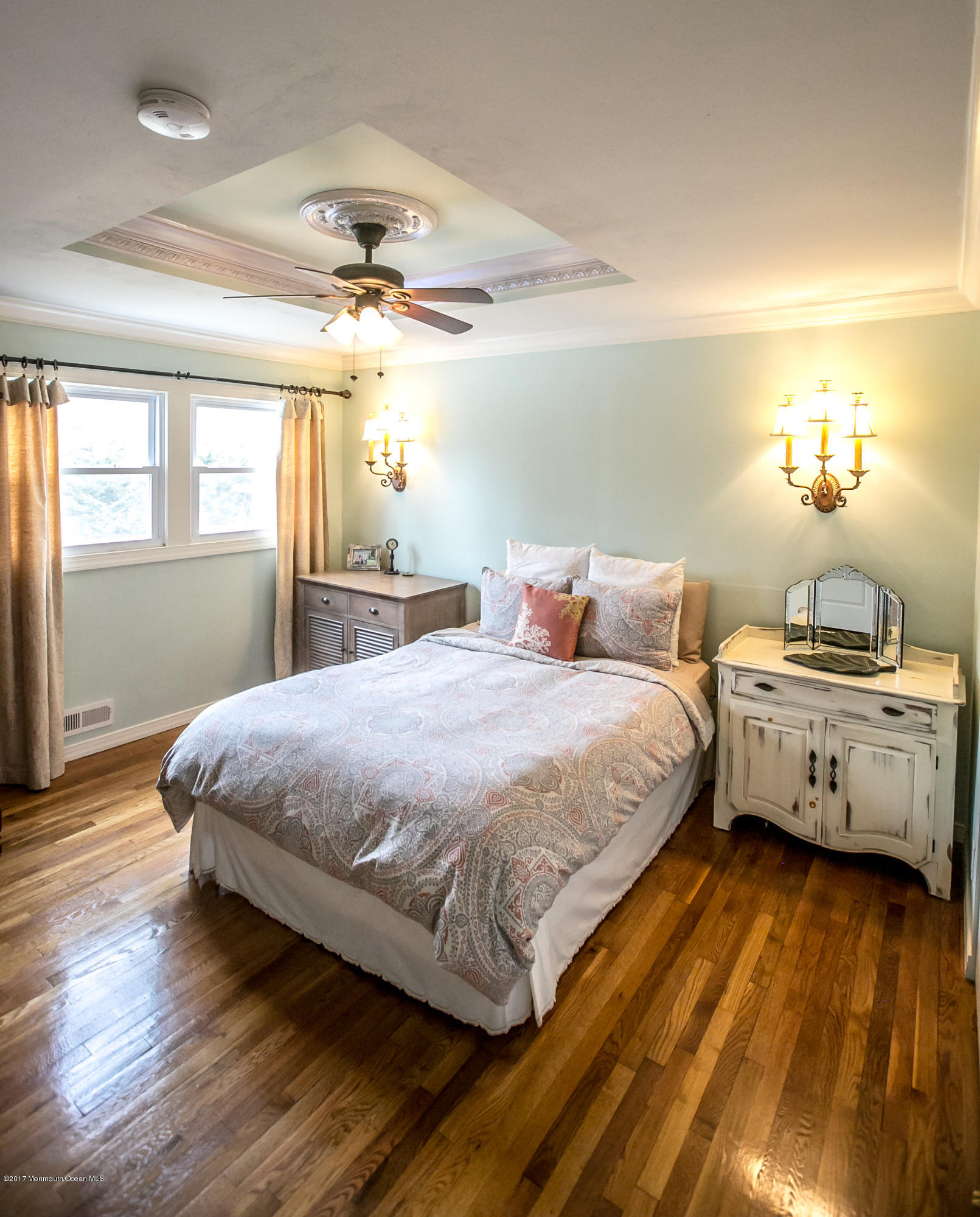 315 Edgemoor Road Middletown, NJ 07718 - Photo 9 of 28 a bedroom with a bed and a chandelier
