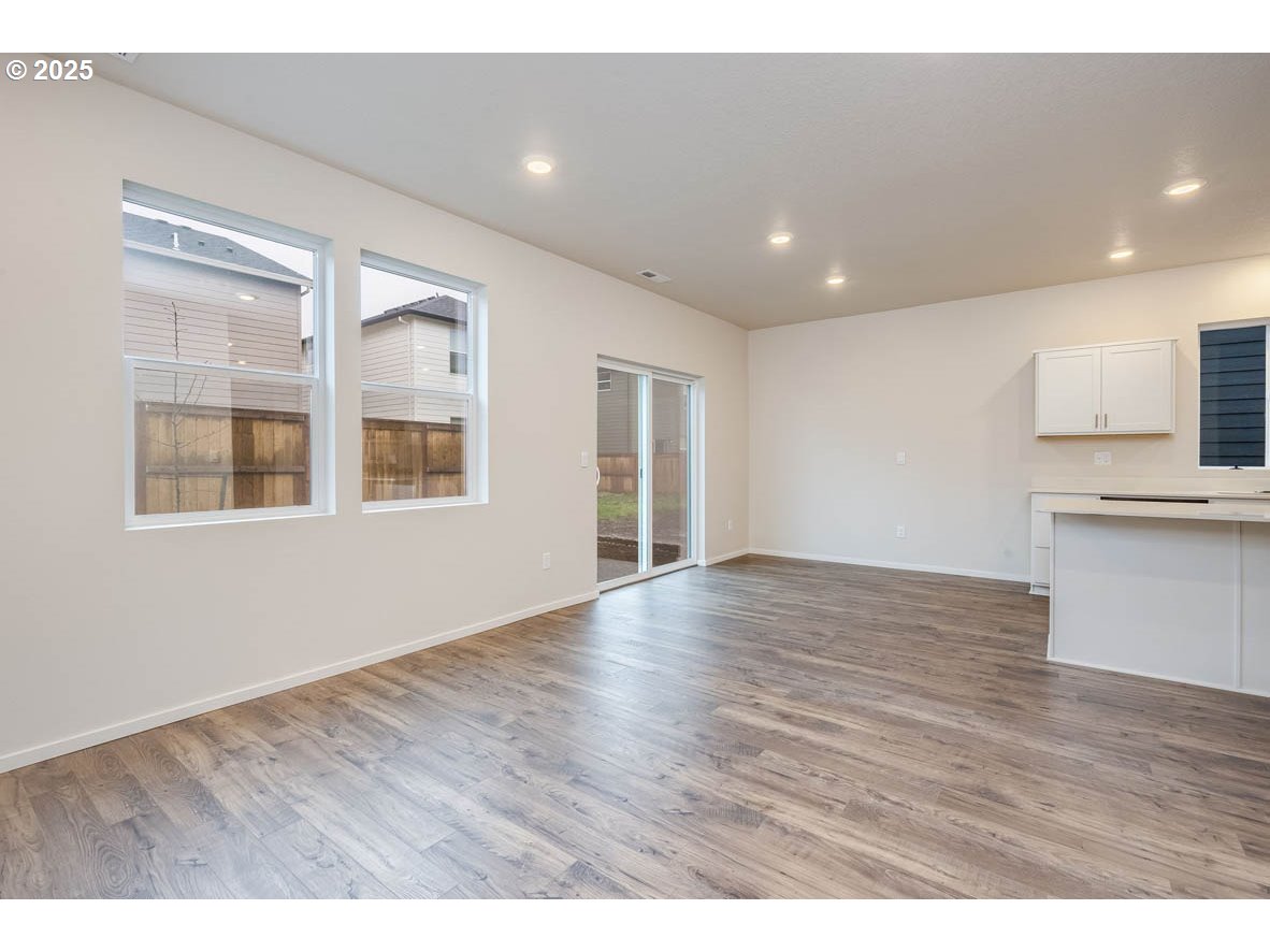 395 Pietro Street Northeast Salem, OR 97301 - Photo 4 of 18 a view of an empty room with wooden floor and a window